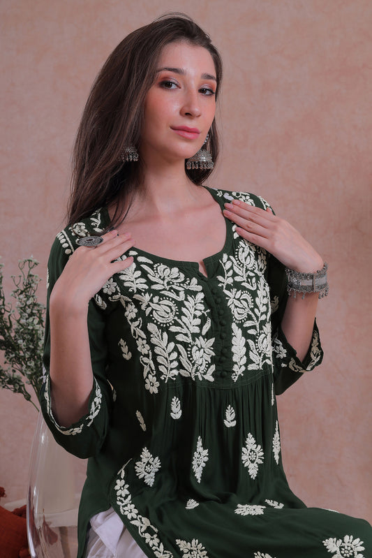 The deep, rich green hue is beautifully adorned with intricate hand-embroidered Chikankari motifs.