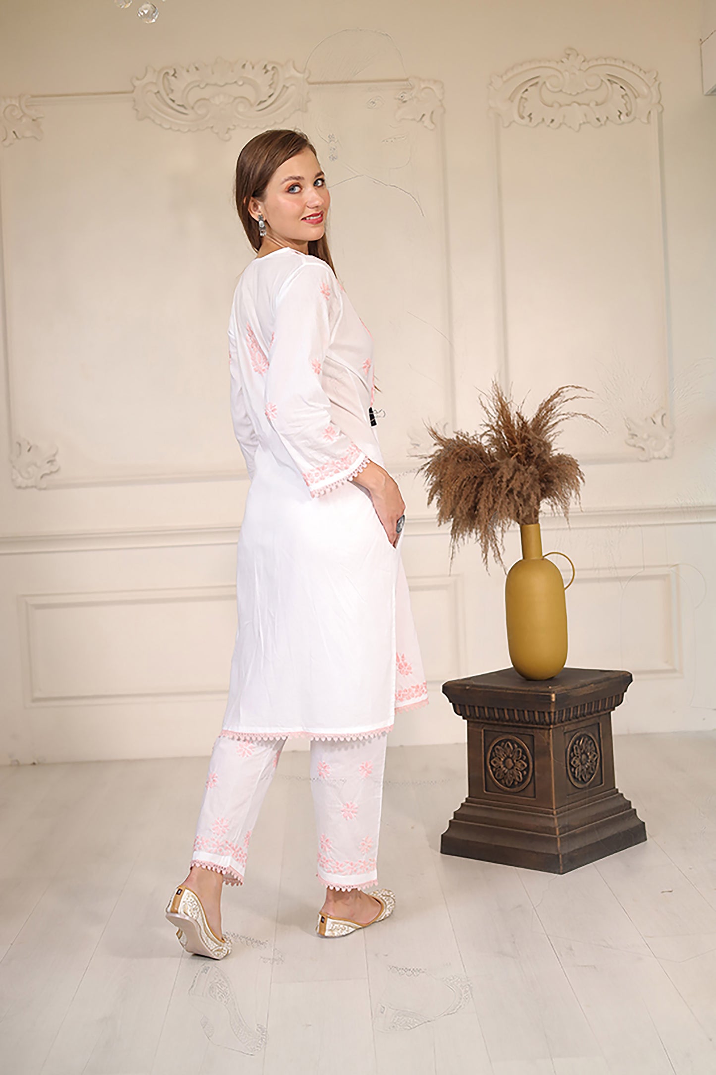 Intricate floral embroidery on front, back and sleeves.