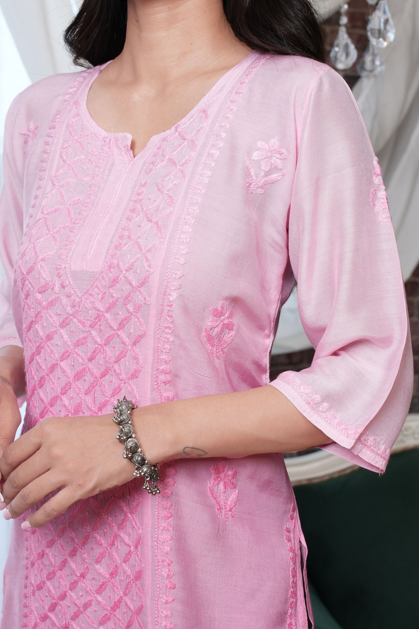 Intricate floral embroidery on front, back and sleeves.