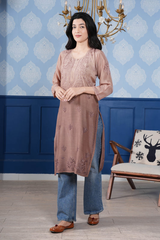 The intricate brown chikankari detailing enhances the kurta’s charm