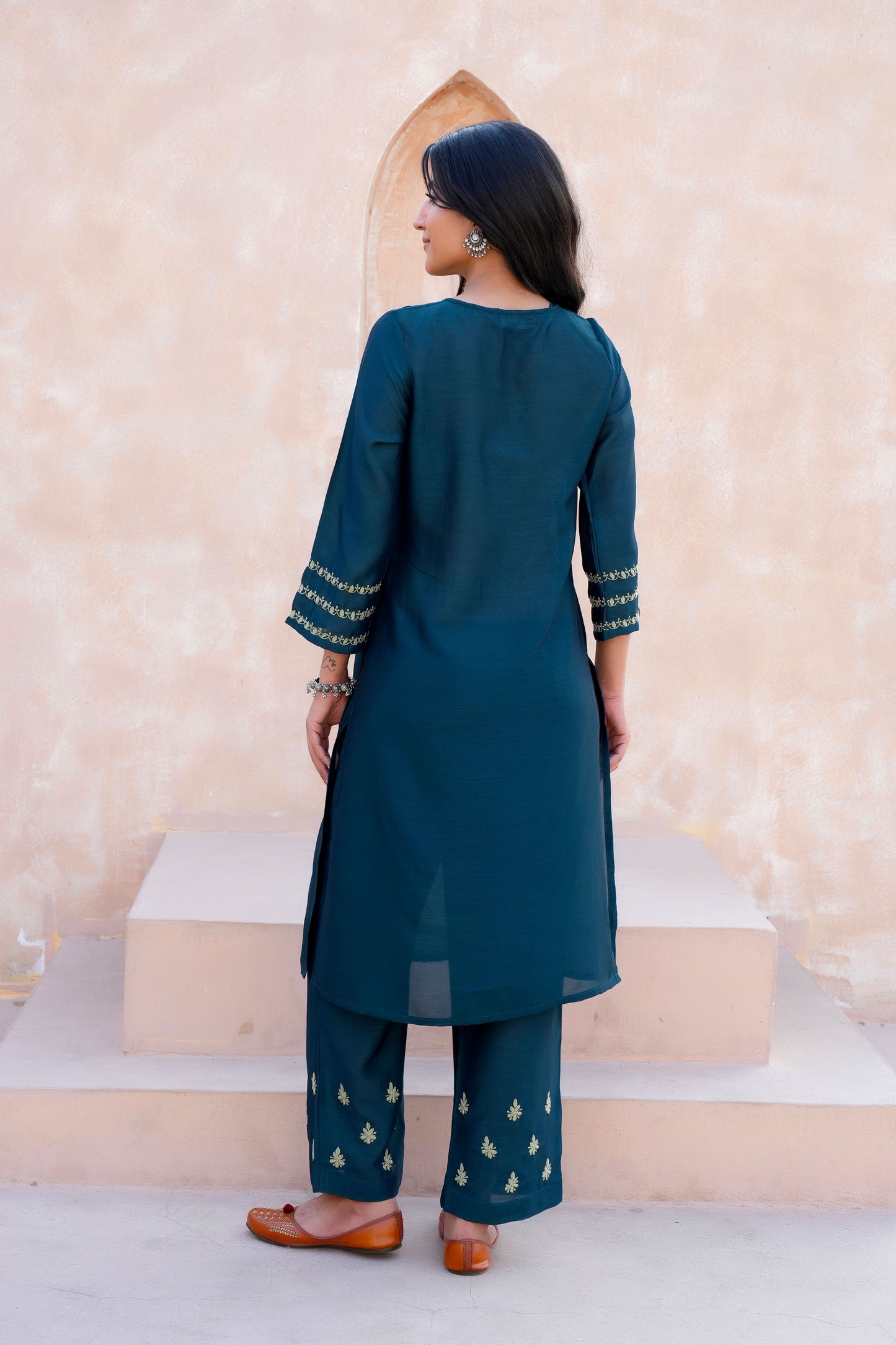 Intricate floral embroidery on front, back and sleeves