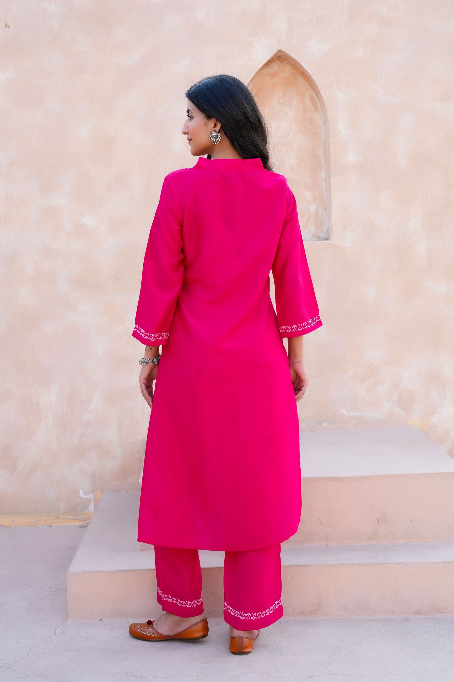Intricate floral embroidery on front, back and sleeves.