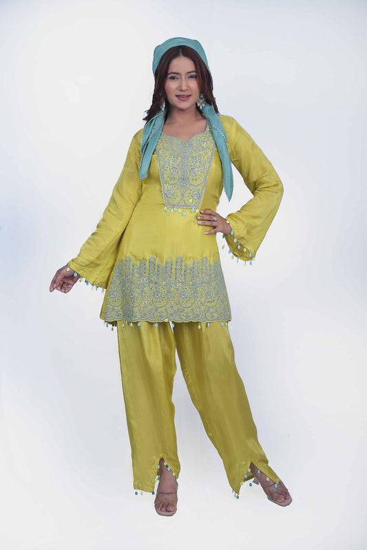 This co-ord set perfect balance of embroidery and seashell tassel.