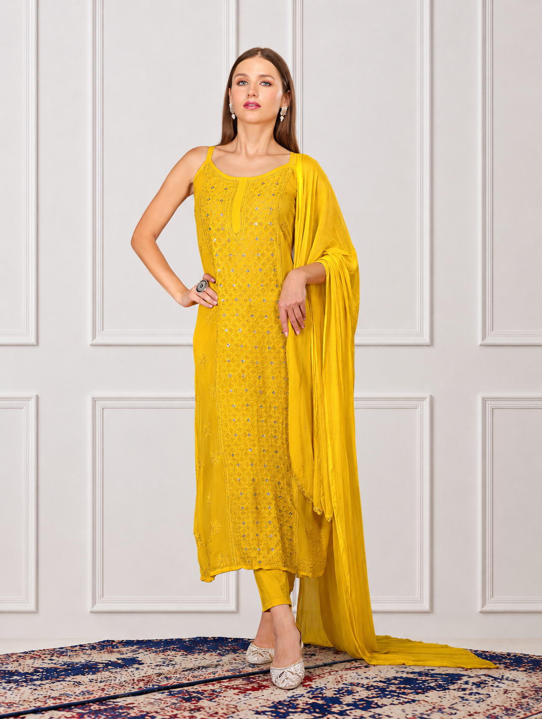 A girl in yellow kurta set Indian ethnic with a matching potli bag flaunting her hand embroidered dress.