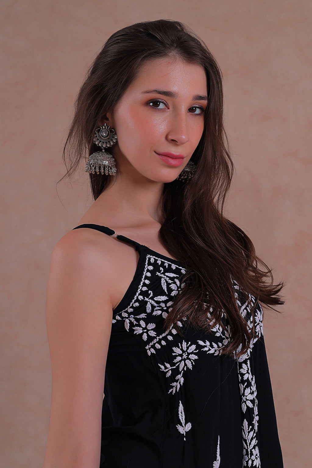 Delicate hand-embroidered Chikankari motifs grace the soft black fabric.