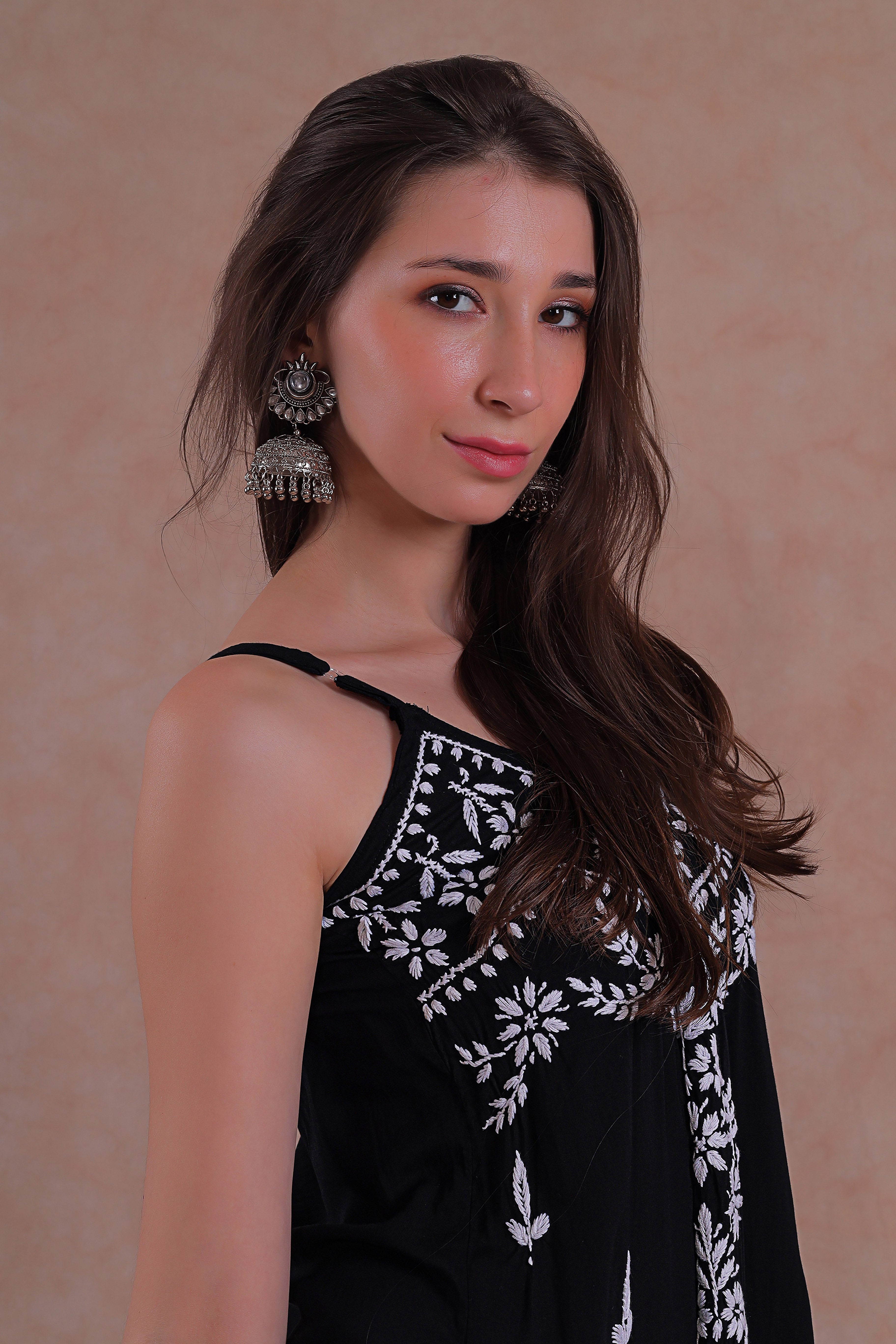 Delicate hand-embroidered Chikankari motifs grace the soft black fabric.