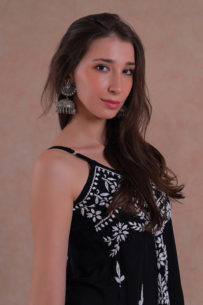 Delicate hand-embroidered Chikankari motifs grace the soft black fabric.