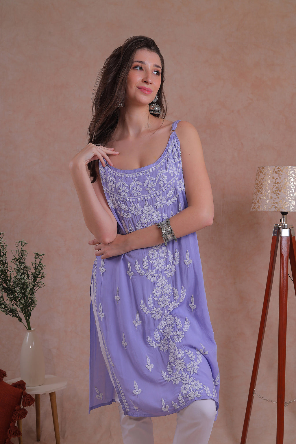 Delicate hand-embroidered Chikankari motifs grace the soft lavender fabric.