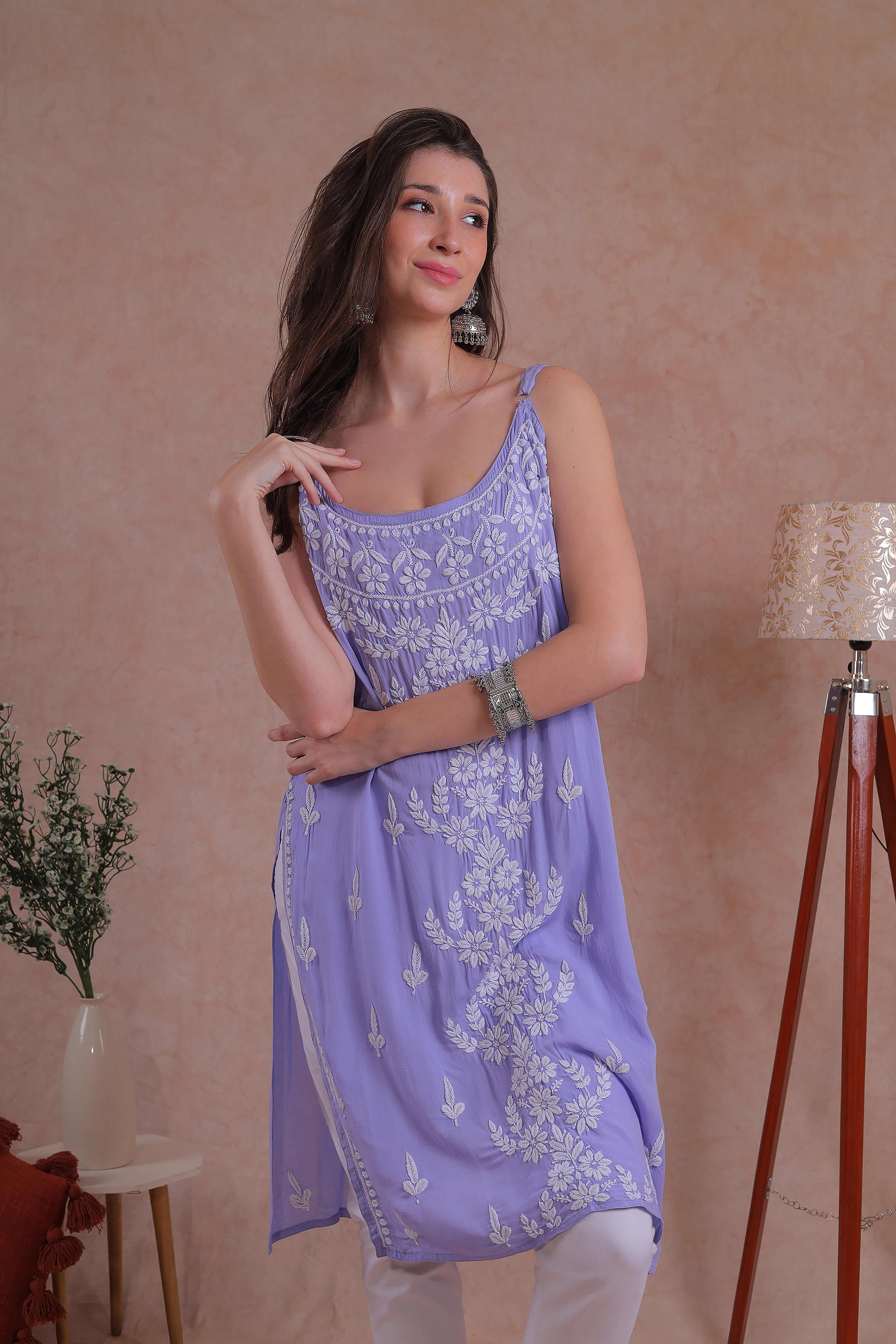 Delicate hand-embroidered Chikankari motifs grace the soft lavender fabric.