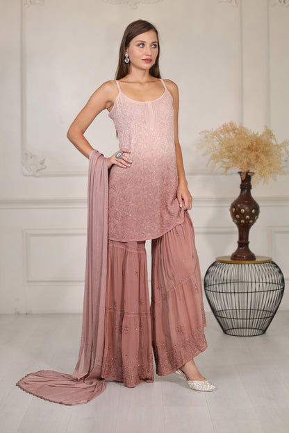 featuring exquisite mukaish work that adds a touch of sparkle to the rich, flowing fabric. 
