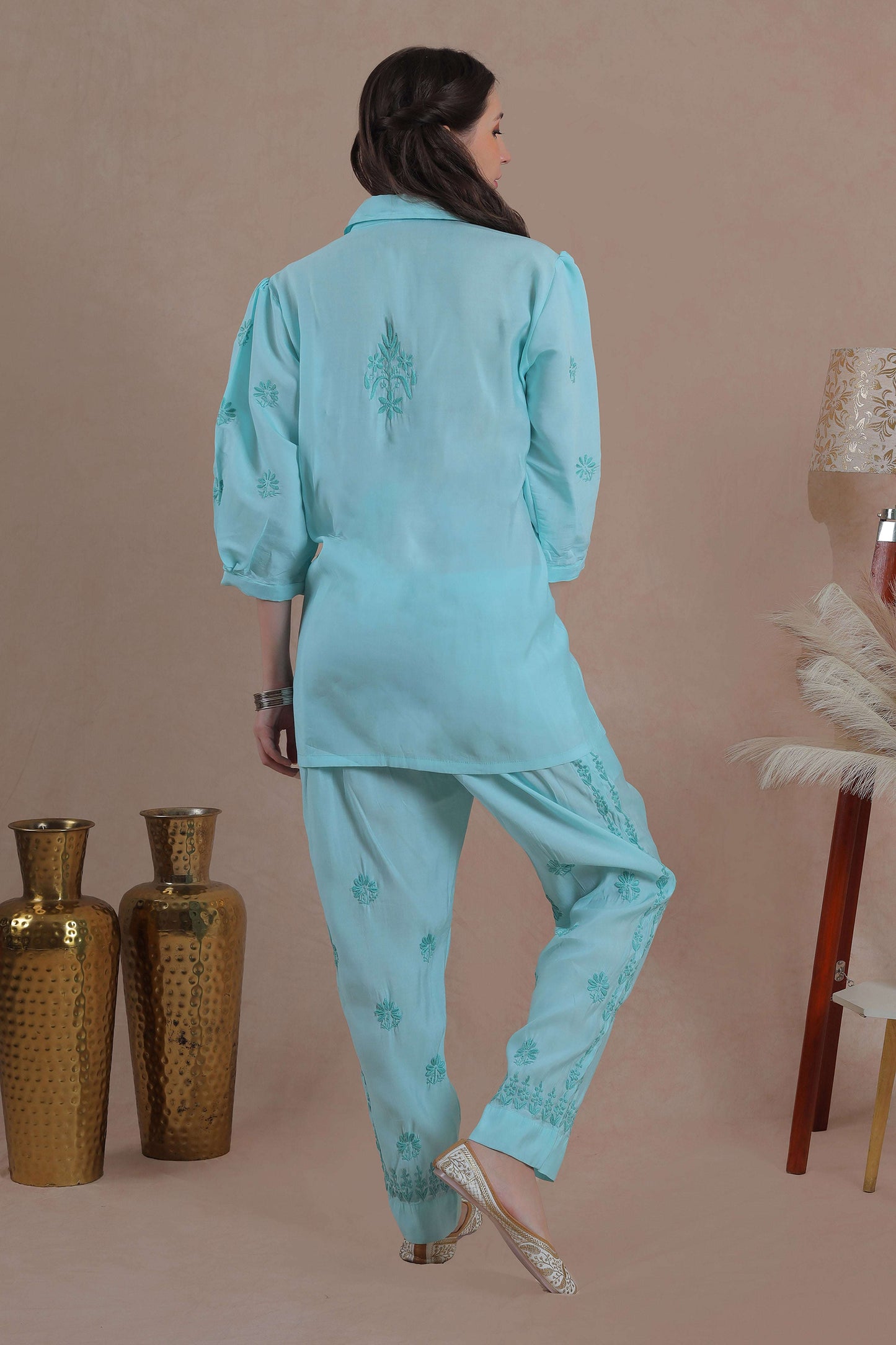 Intricate floral embroidery on front, back and sleeves.
