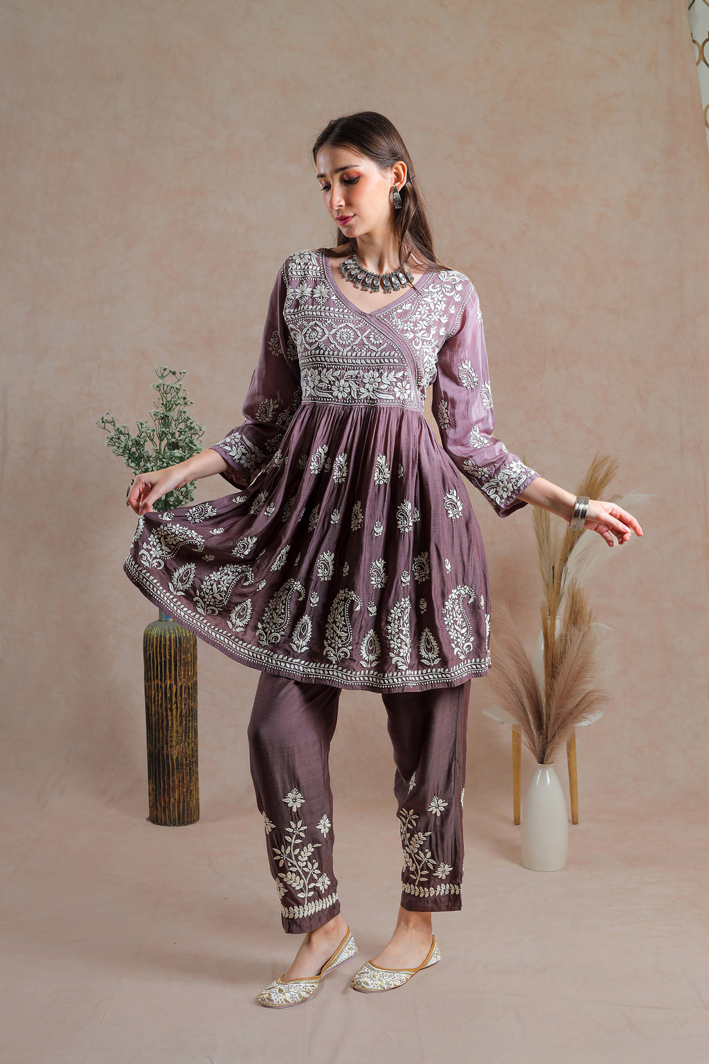 This Muslin asymmetrical yoke frock style kurta with pant.