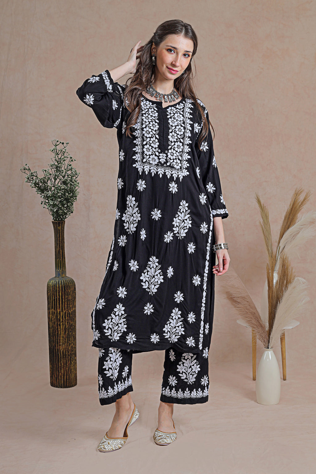 Chikankari black kurta set, a classic ensemble adorned with intricate hand-embroidered Chikankari motifs. 