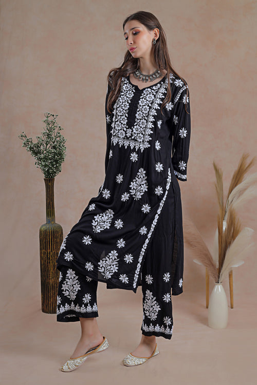 The rich black hue enhances the delicate embroidery.