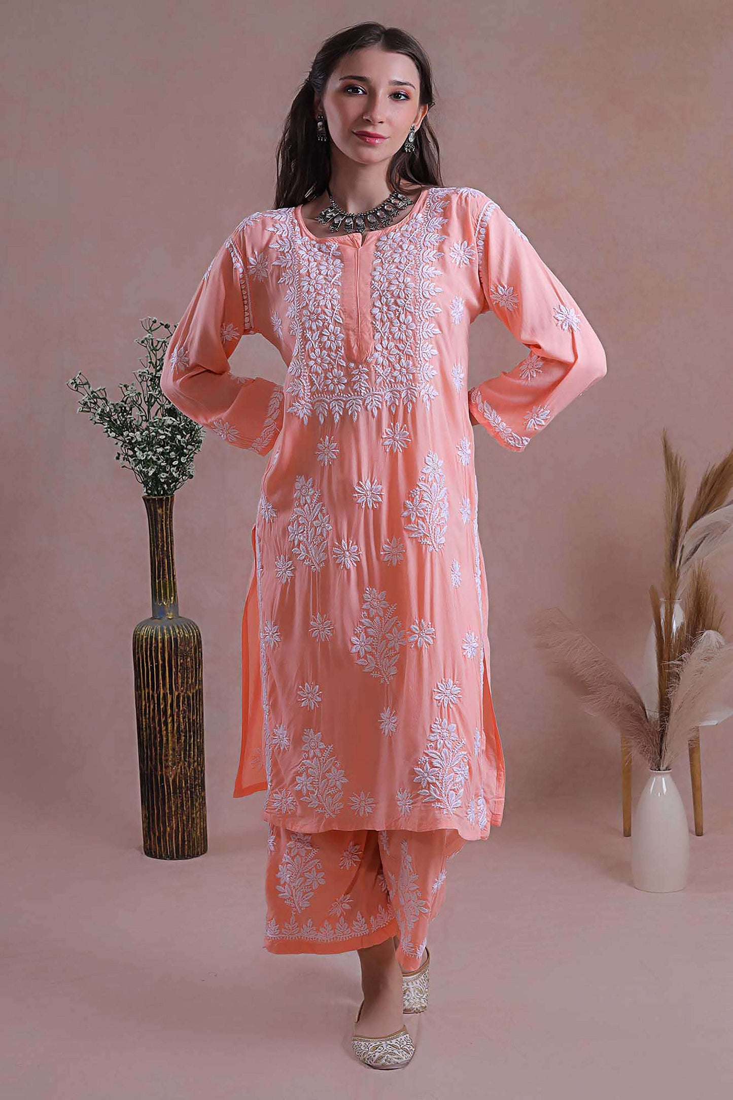 This kurta set classic ensemble adorned with intricate hand-embroidered Chikankari motifs