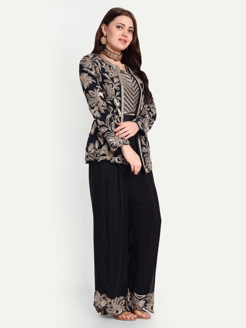 The bralette and coat are designed with heavy needlework featuring the floral / leaves design