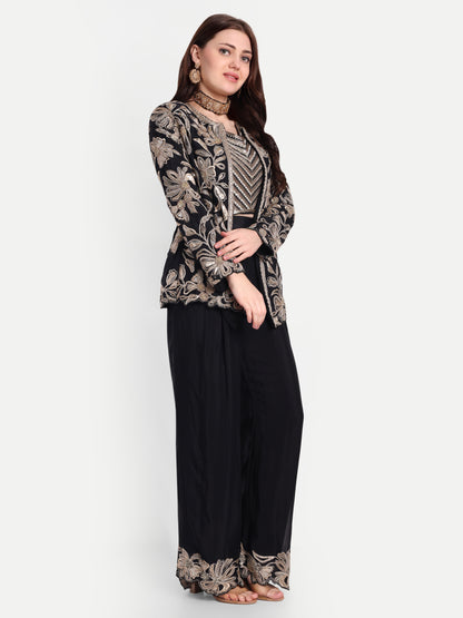 The bralette and coat are designed with heavy needlework featuring the floral / leaves design