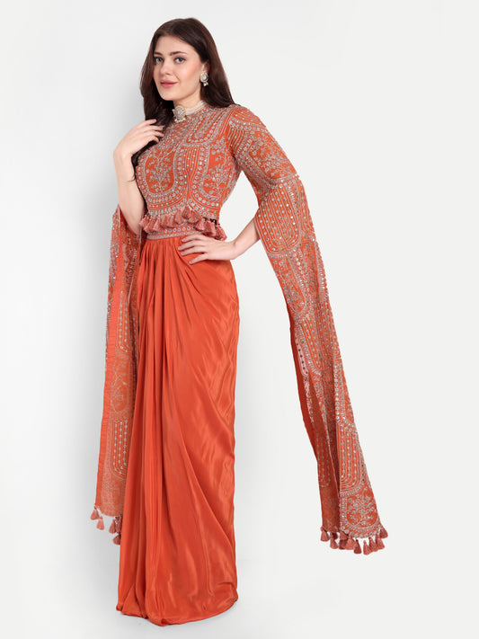 The blouse has mirror work all over and is adorned with tassels. 