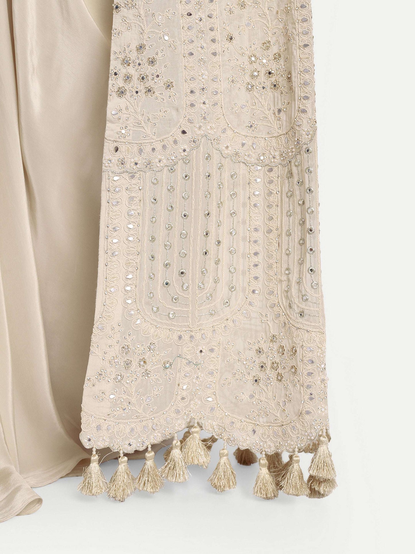 Slit Sleeve mirror work all over and is adorned with tassels