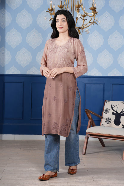 The intricate brown chikankari detailing enhances the kurta’s charm