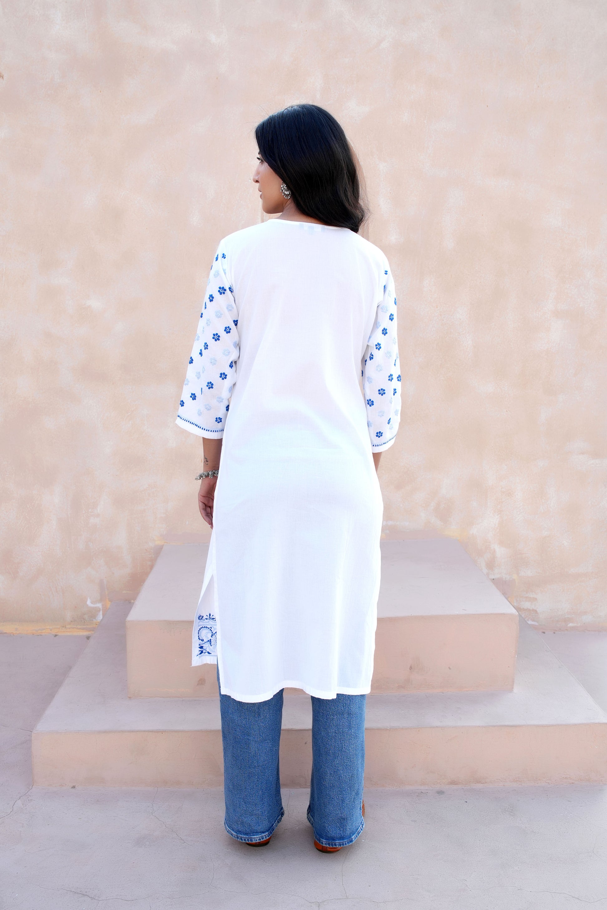 Intricate floral embroidery on front  and sleeves.
