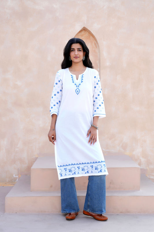 The intricate blue chikankari detailing enhances the kurta’s charm,