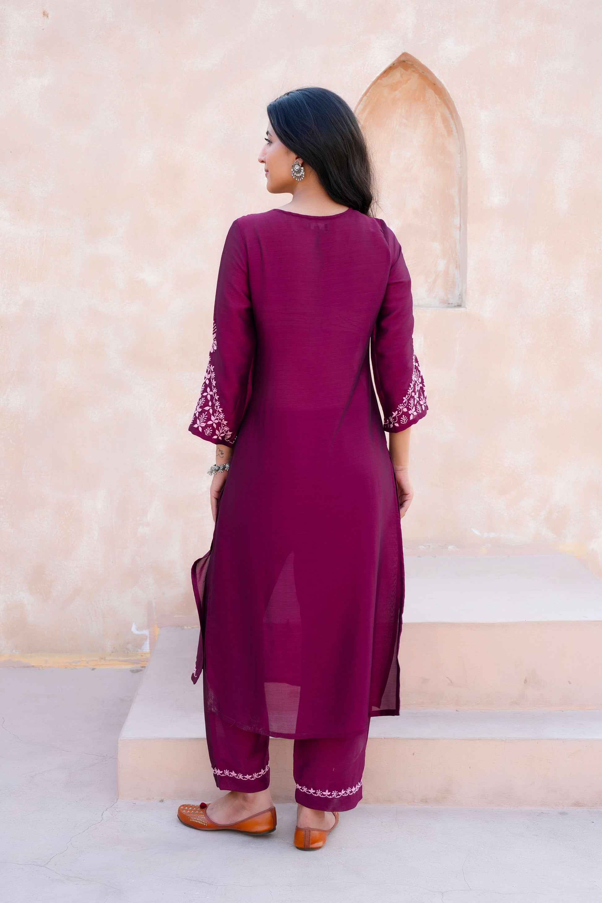 Intricate floral embroidery on front, back and sleeves.