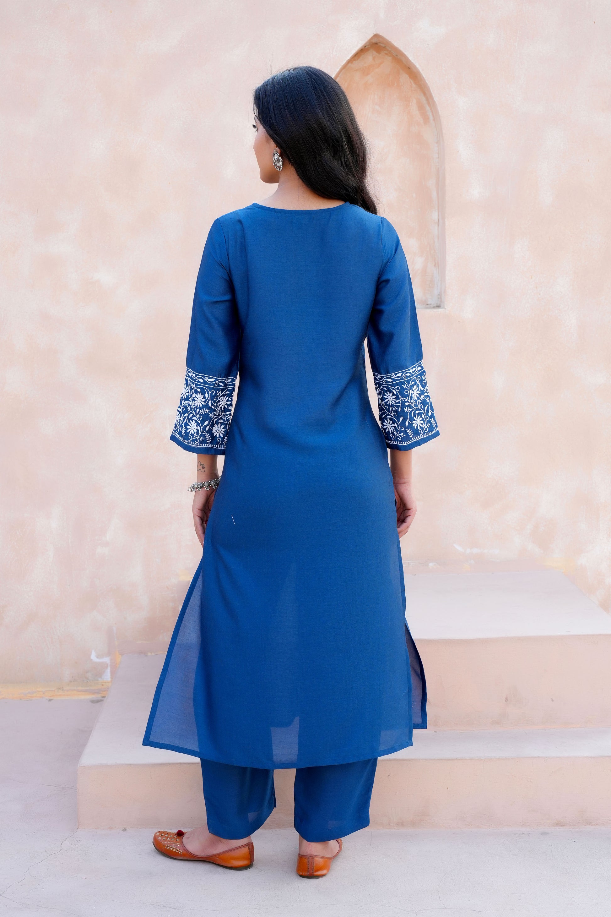 Intricate floral embroidery on front and sleeves.