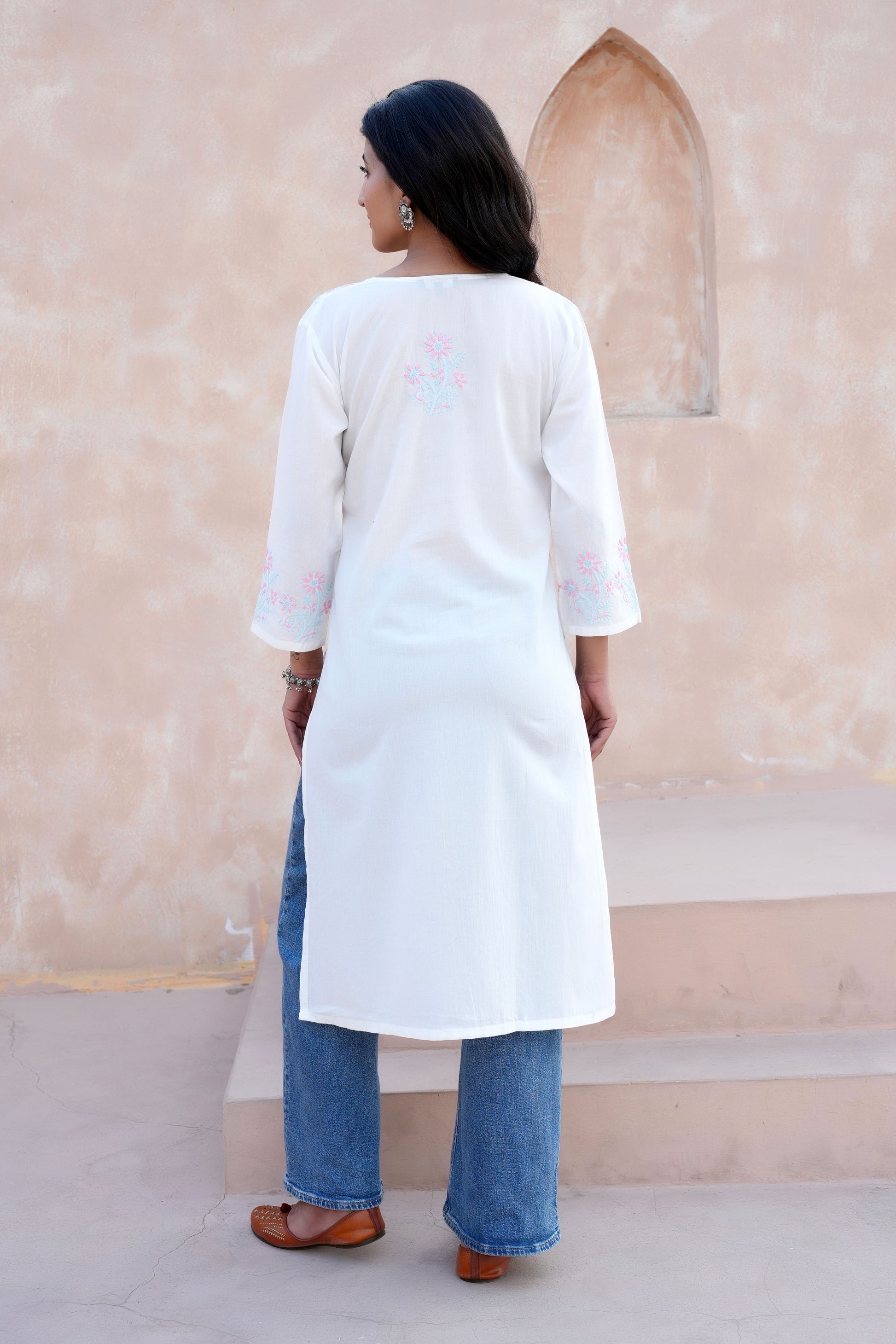 Intricate floral embroidery on front, back and sleeves.