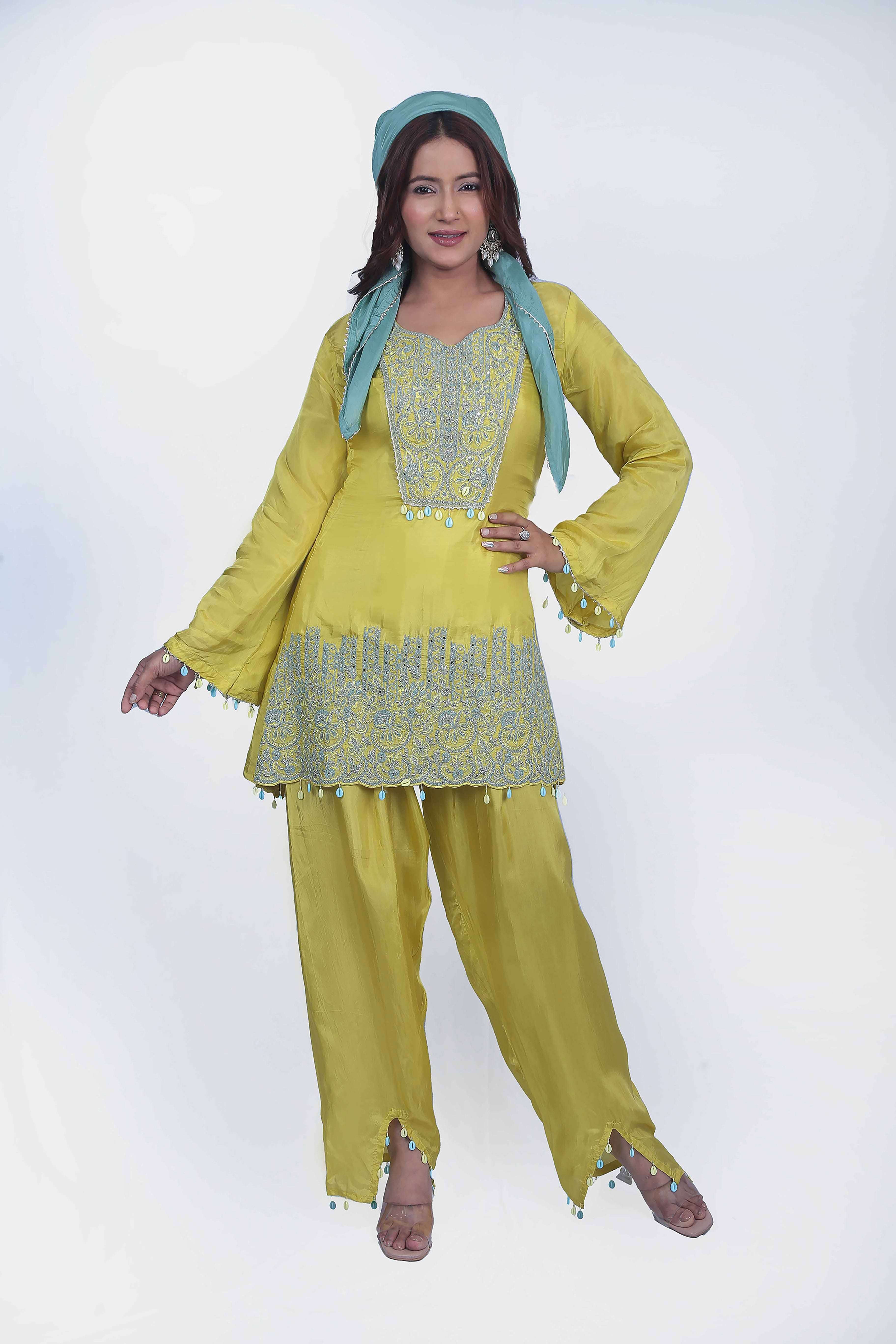 This co-ord set perfect balance of embroidery and seashell tassel.