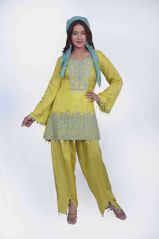 This co-ord set perfect balance of embroidery and seashell tassel.