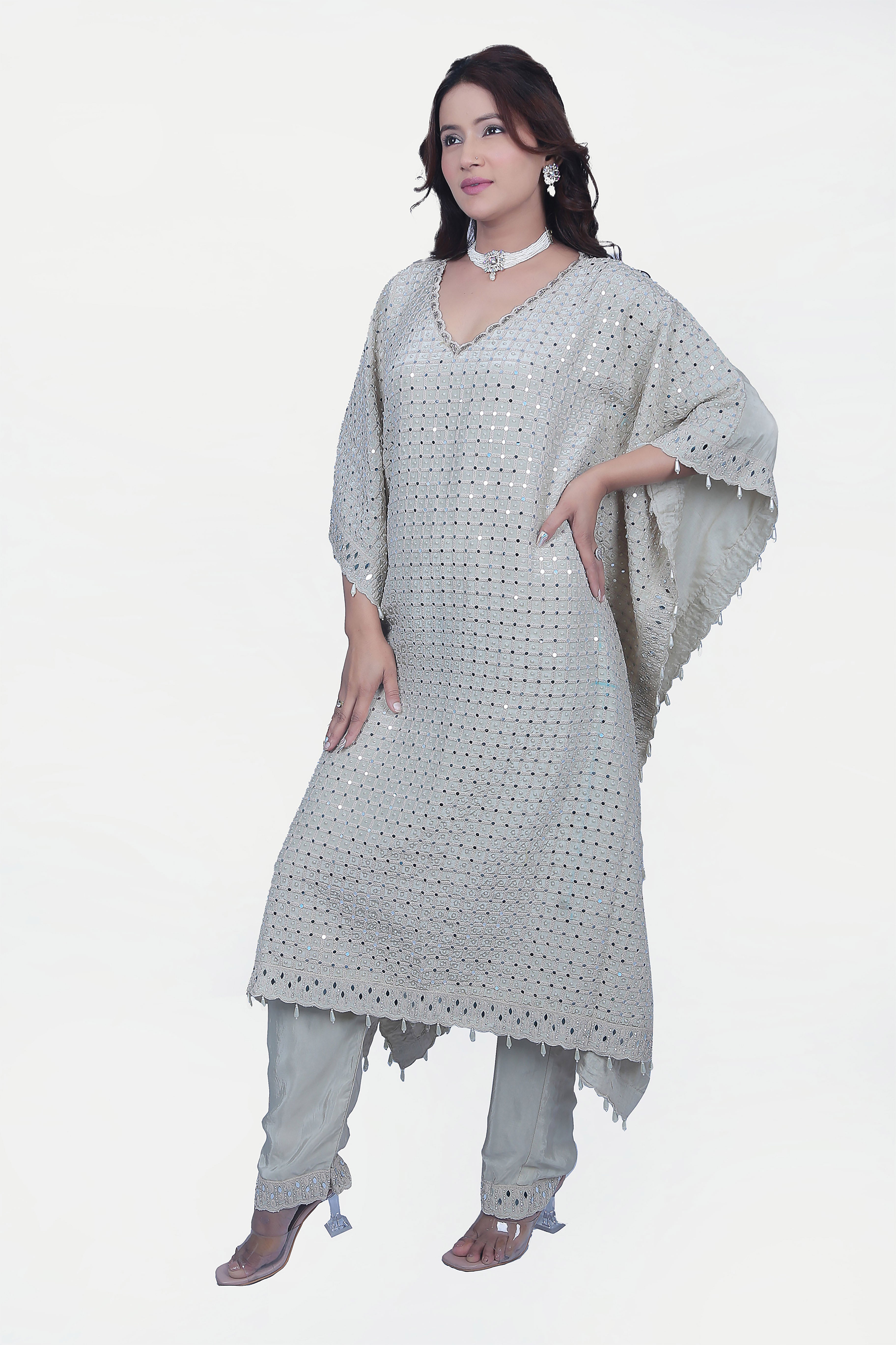 This fully embellished kaftan set is one of the go to styles that is ready to wear with matching pants.