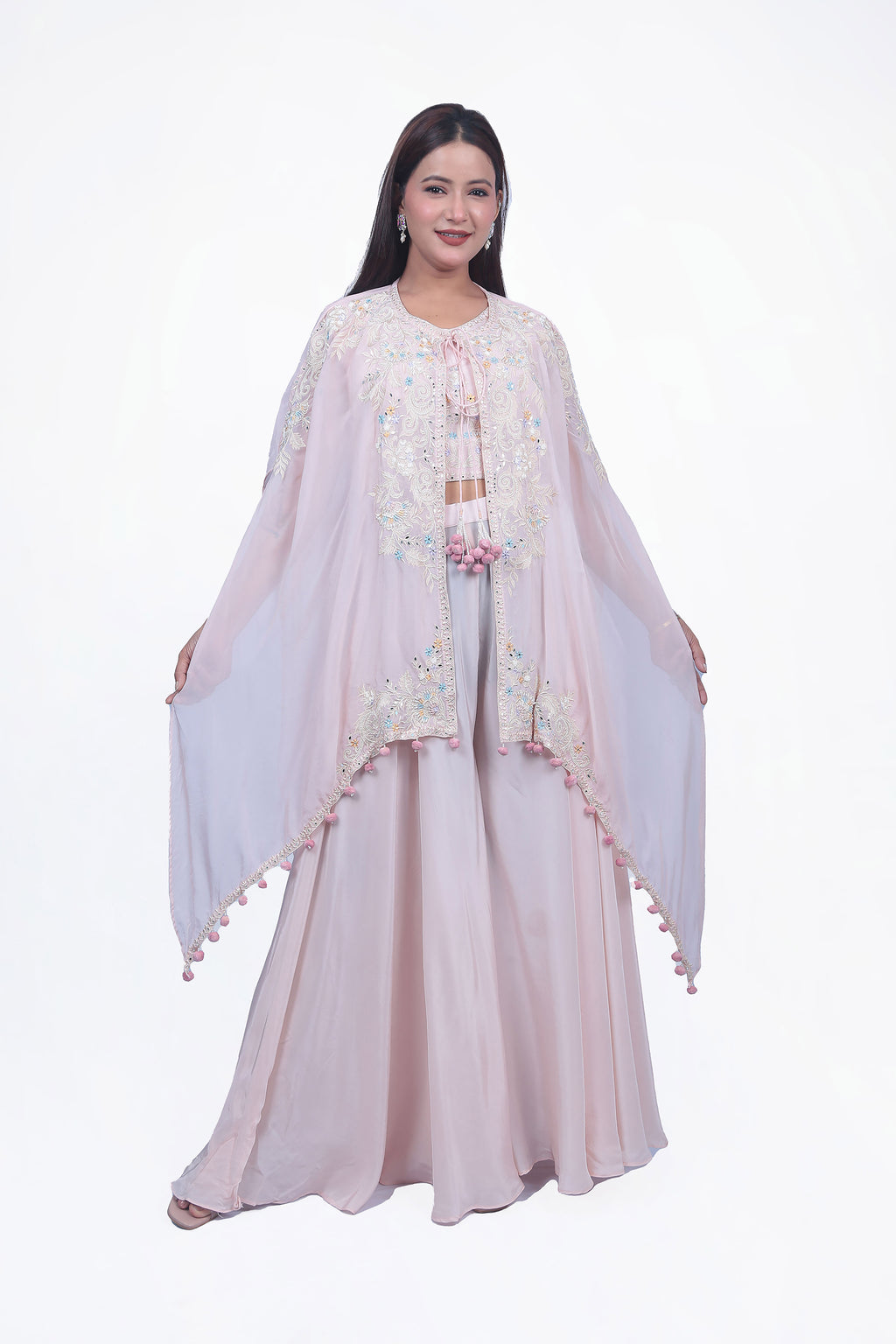 This peach colored fabric palazzo/sharara set features a stunning design