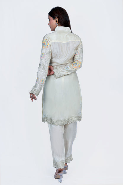 This Off white co-ord set Silk fabric for both top and bottom, Multicoloured Thread work on crepe