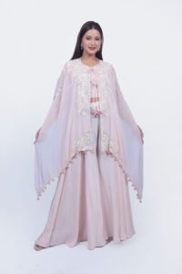 Peach thread work top with sharara set. The cape is designed with elegant threadwork and white sequinwork.