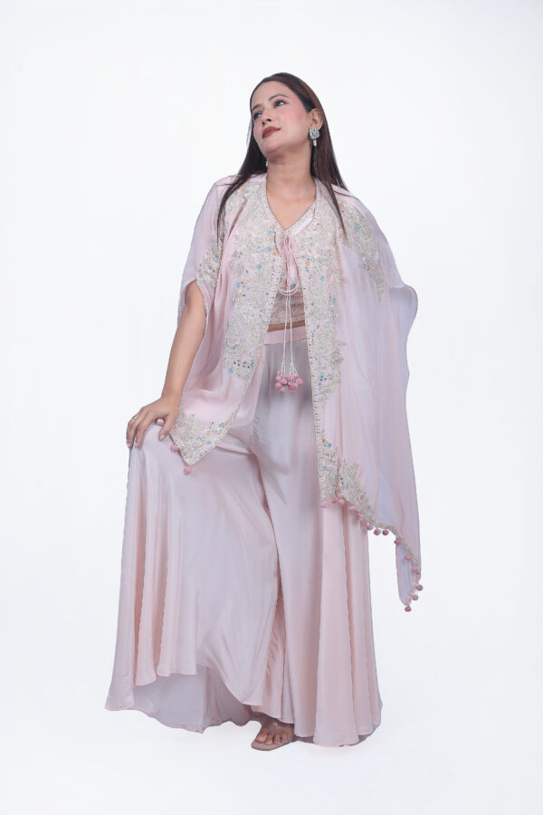 Peach thread work top with sharara set. The cape is designed with elegant threadwork and white sequinwork.