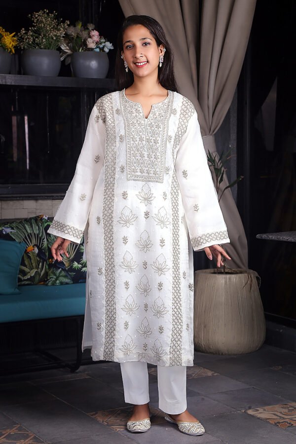 Off-white organza chikankari suit, featuring intricate contrast thread embroidery and delicate pearl embellishments.