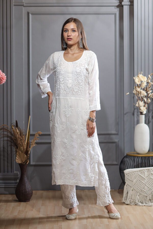 white coloured Kurta Set features a stunning design, with frill detailing.