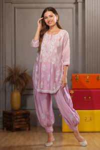 Pretty woman wearing pink Kurta and afghani pant with detailed chikankari embroidery work on it.