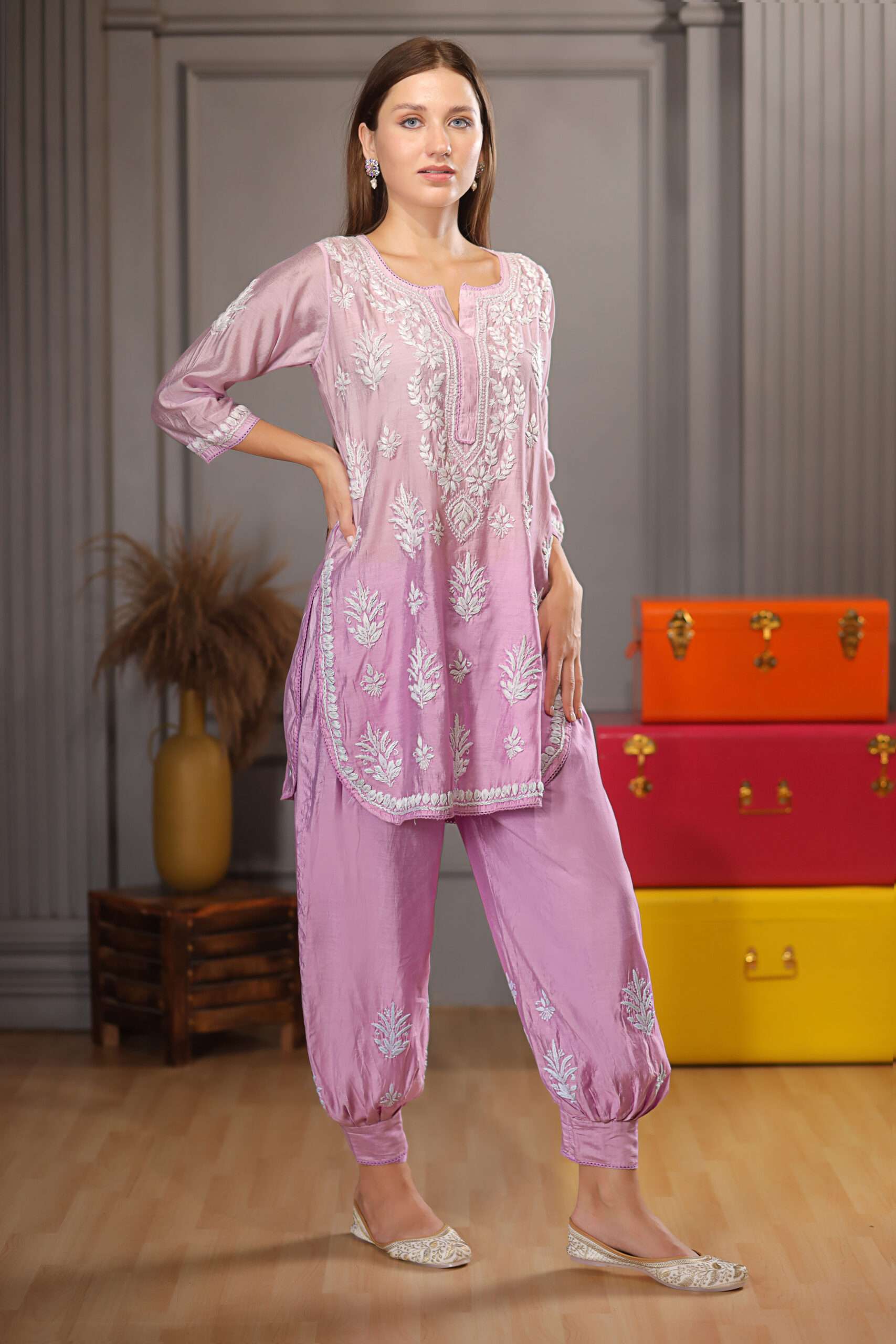 Pretty woman wearing pink Kurta and afghani pant with detailed chikankari embroidery work on it.