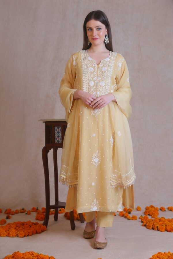 Yellow silk organza kurta set, embellished with dainty cutdana, sequins and pote.